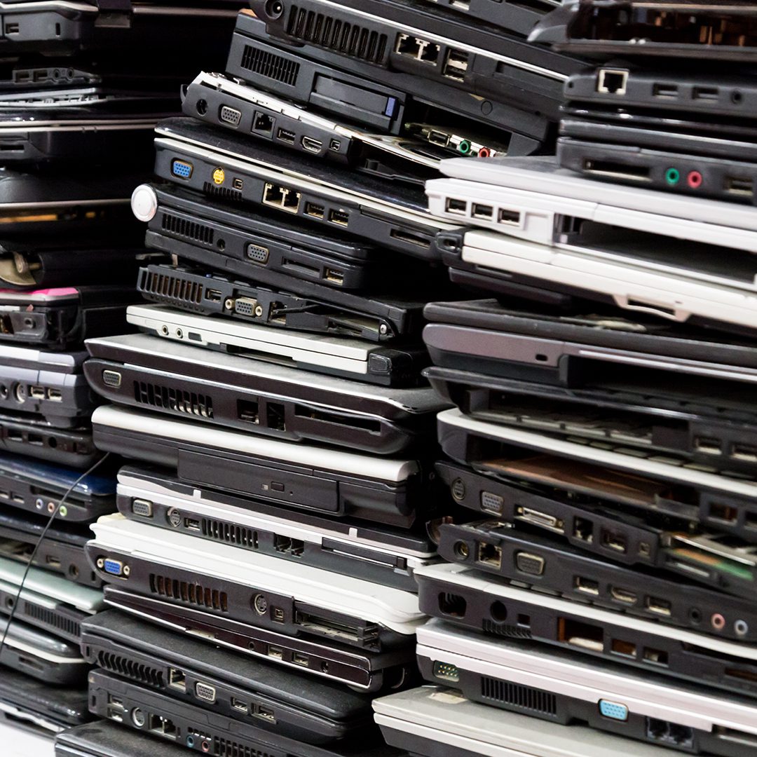 stacks of outdated laptop computers