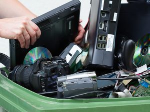 putting old computer hardware into a trash can