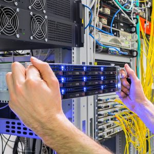 Image of a man removing a server from a rack